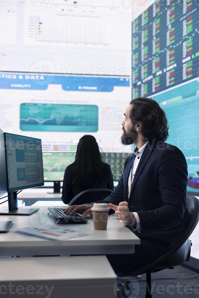 Corporate employee looking into project details and timetables in open coworking space, establishing budget and operations to accomplish goals in a competitive business environment. photo