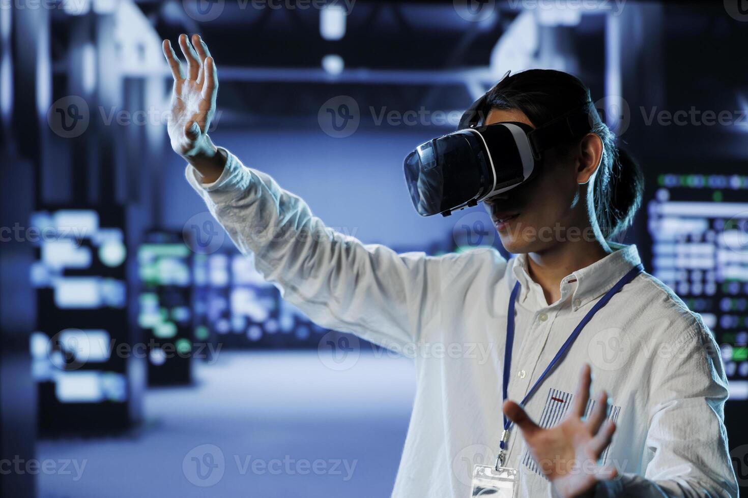 Certified developer in data center uses virtual reality to prevent system overload. Expert with VR goggles in server farm ensuring enough network bandwidth for smooth operations photo
