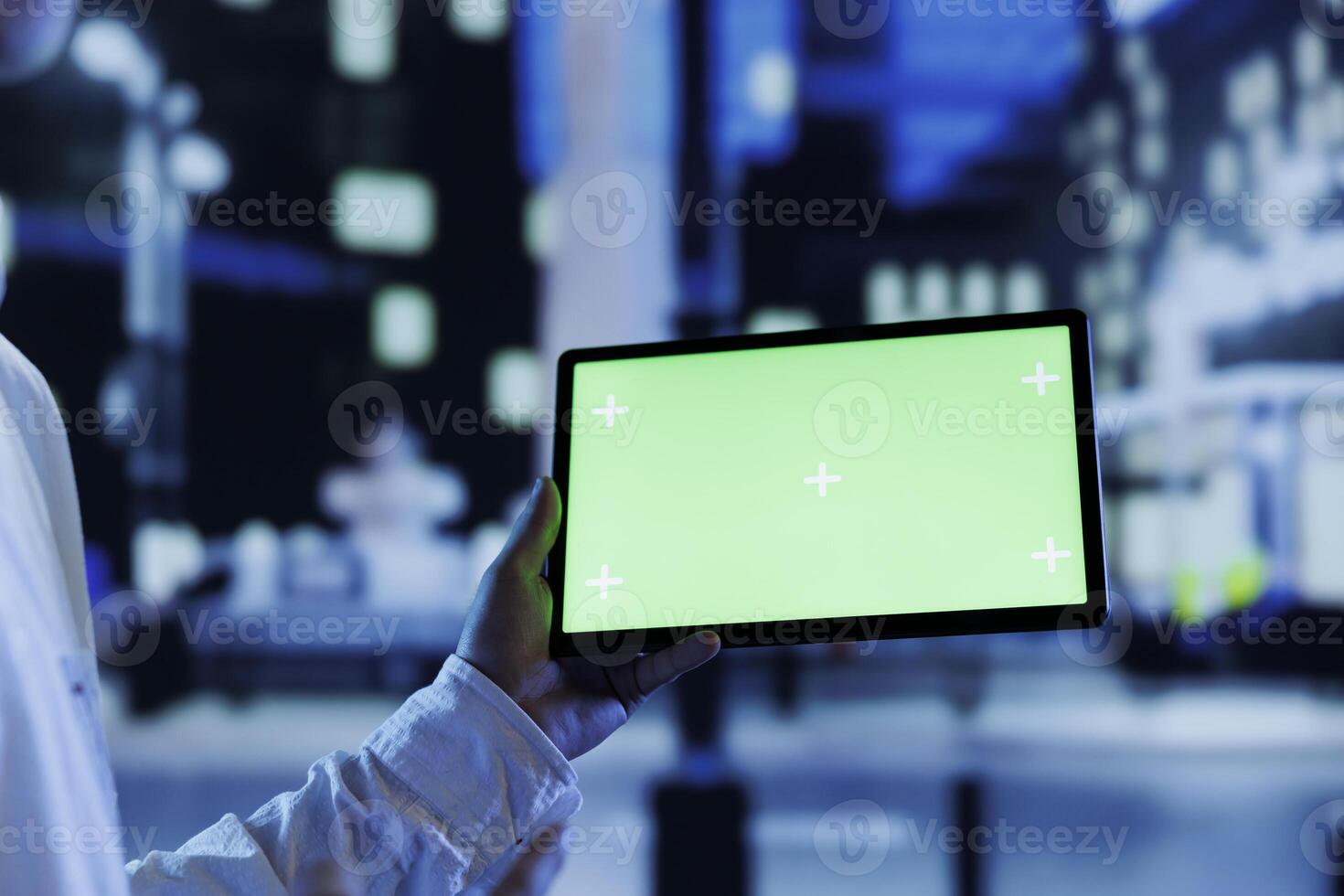 Man having fun walking around city at night, watching videos using mockup tablet, close up. Citizen using green screen device in landscape mode while strolling in empty metropolitan setting photo