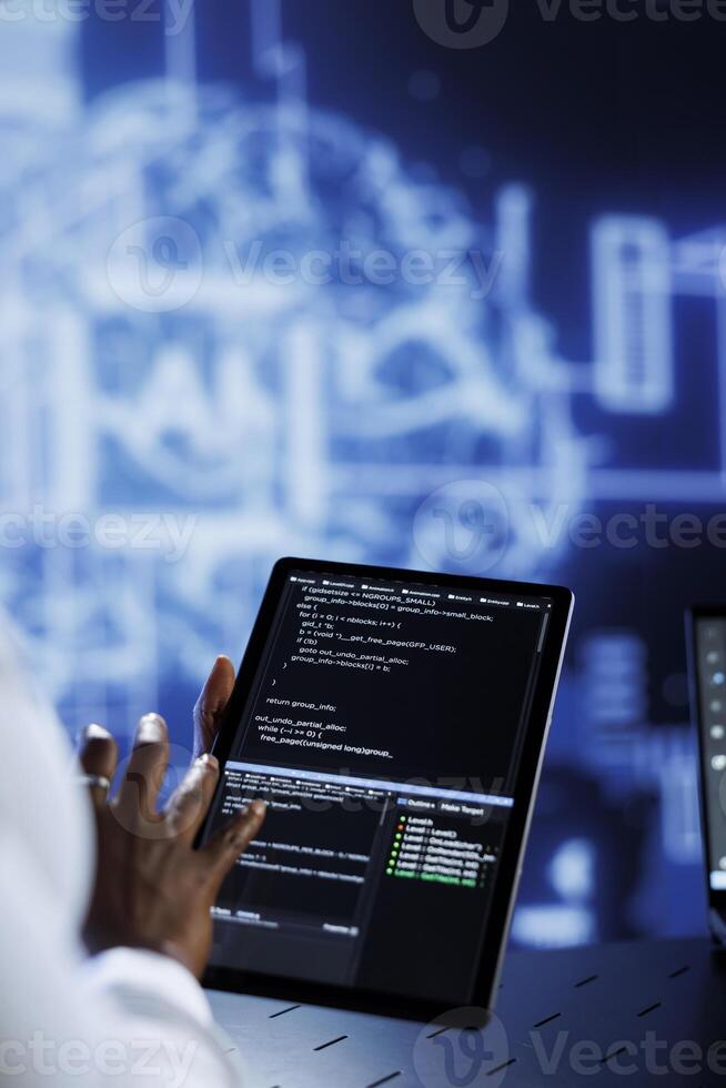 Trained developer updates neural networks made up of interconnected nodes, writing intricate binary code scripts on tablet. Expert uses programming to upgrade AI simulation model, blurry background photo