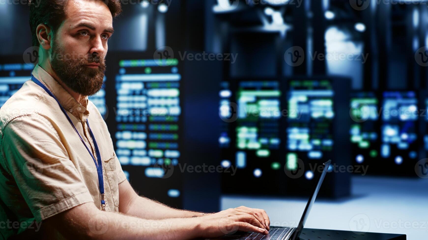 Skilled IT programmer imputing high tech facility hub disaster recovery plan on laptop to provide smooth restoration of service, limiting damage and maximizing operations uptime photo