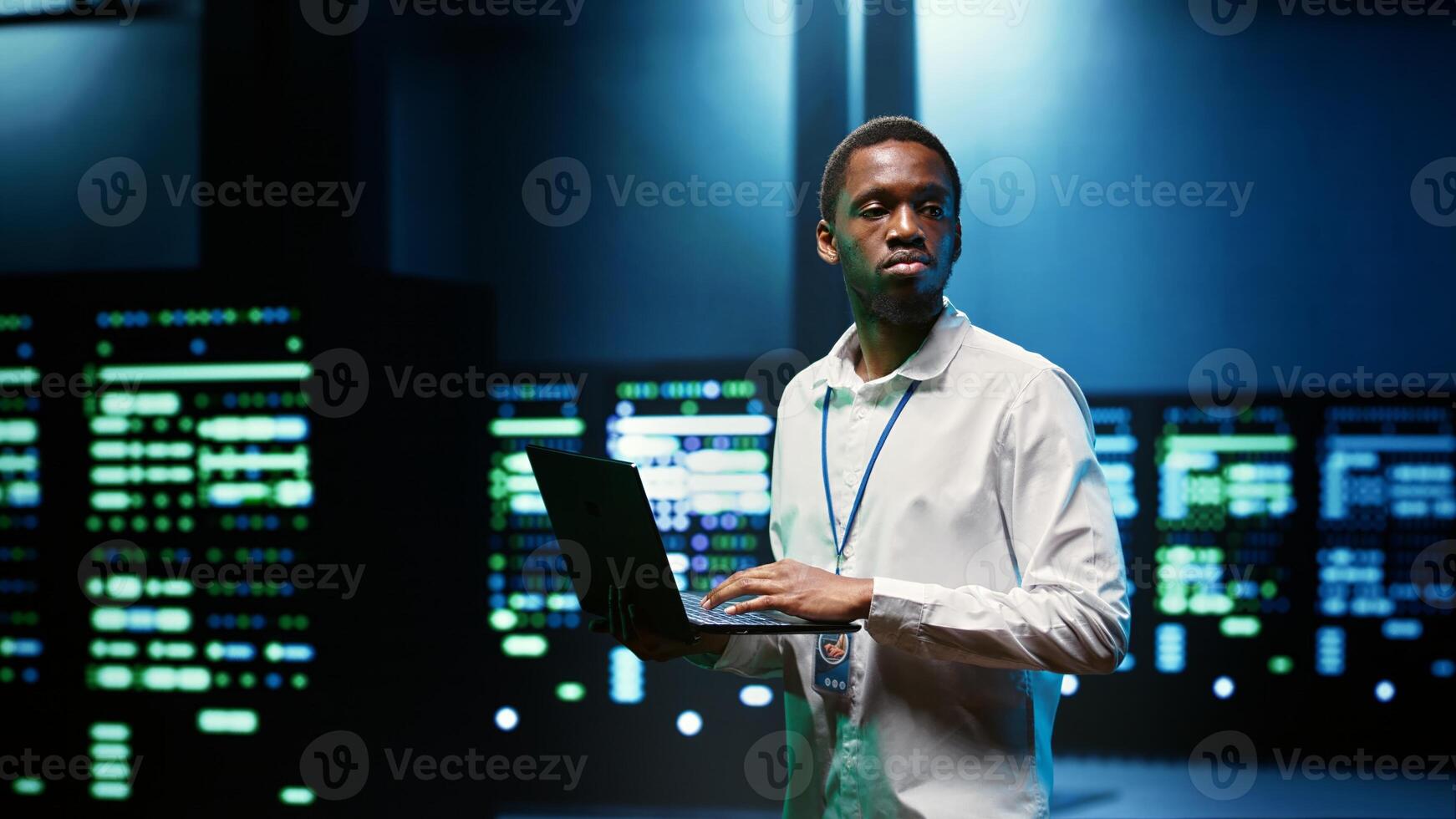 IT developer in server room using laptop to find network issues affecting supercomputer performance and connectivity, leading to slow data transfer rates and poor client communication photo