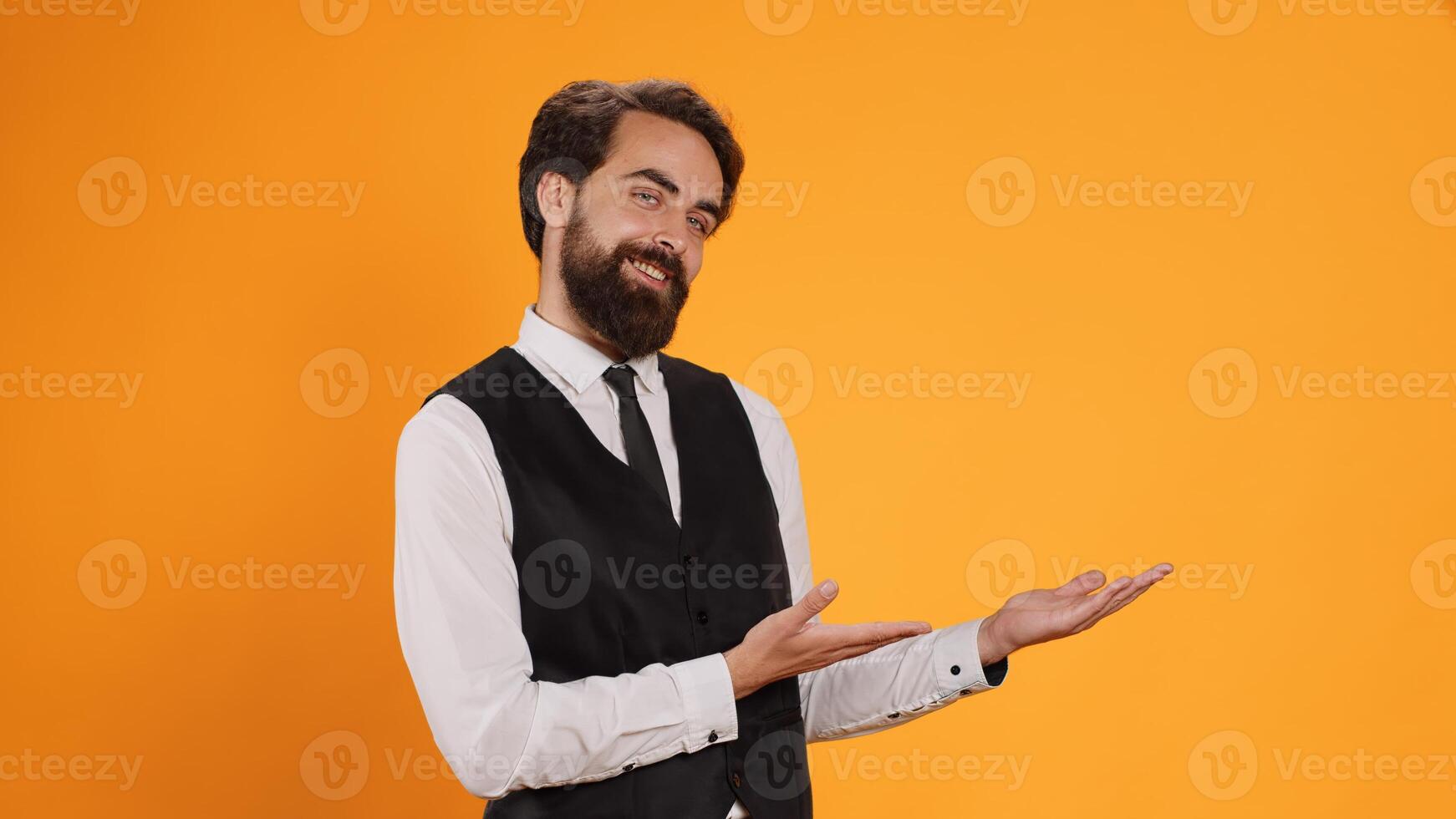 Experienced waiter associated with catering business, referring to left or right wings serving dishes at five star dining establishment. Sophisticated culinary staff offering clients instructions. photo