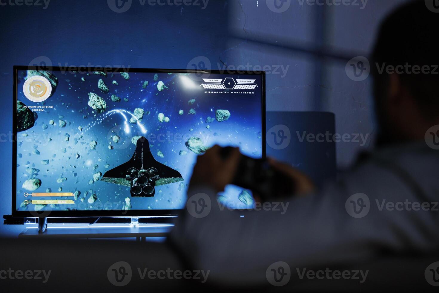 At night, dedicated person participates in online battle with long range firearms while playing galactic shooting games. African american nerd having fun with roleplaying gaming challenge. photo