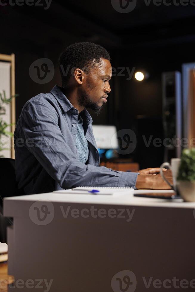 Ambitious pupil acquires knowledge in business administration via web based training program, focusing on webinar with certified mentor. Young man decided to study banking and commerce. photo