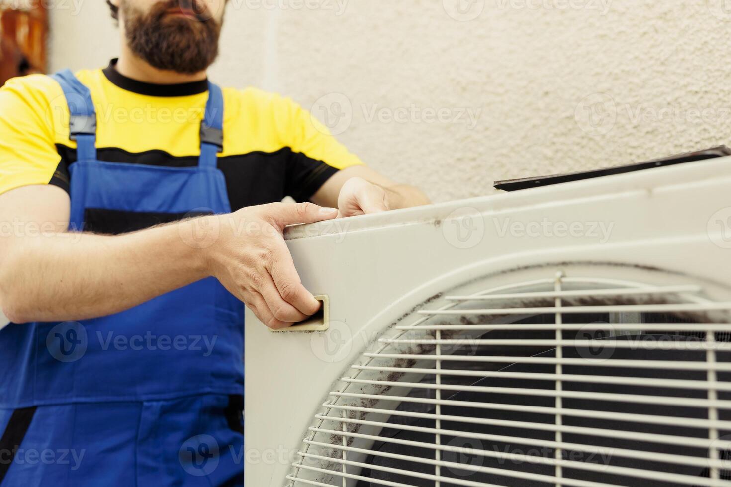 Knowleadgeable technician getting new external hvac system ready after replacing damaged unit. Efficient mechanic employed to install air conditioner and make sure it operates at maximum performance photo