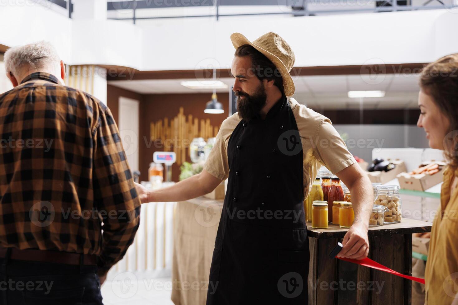 Newly opened zero waste shop owner inviting clients in after preparing organic food stock. Entrepreneur cutting red ribbon, celebrating new local neighborhood store grand opening photo