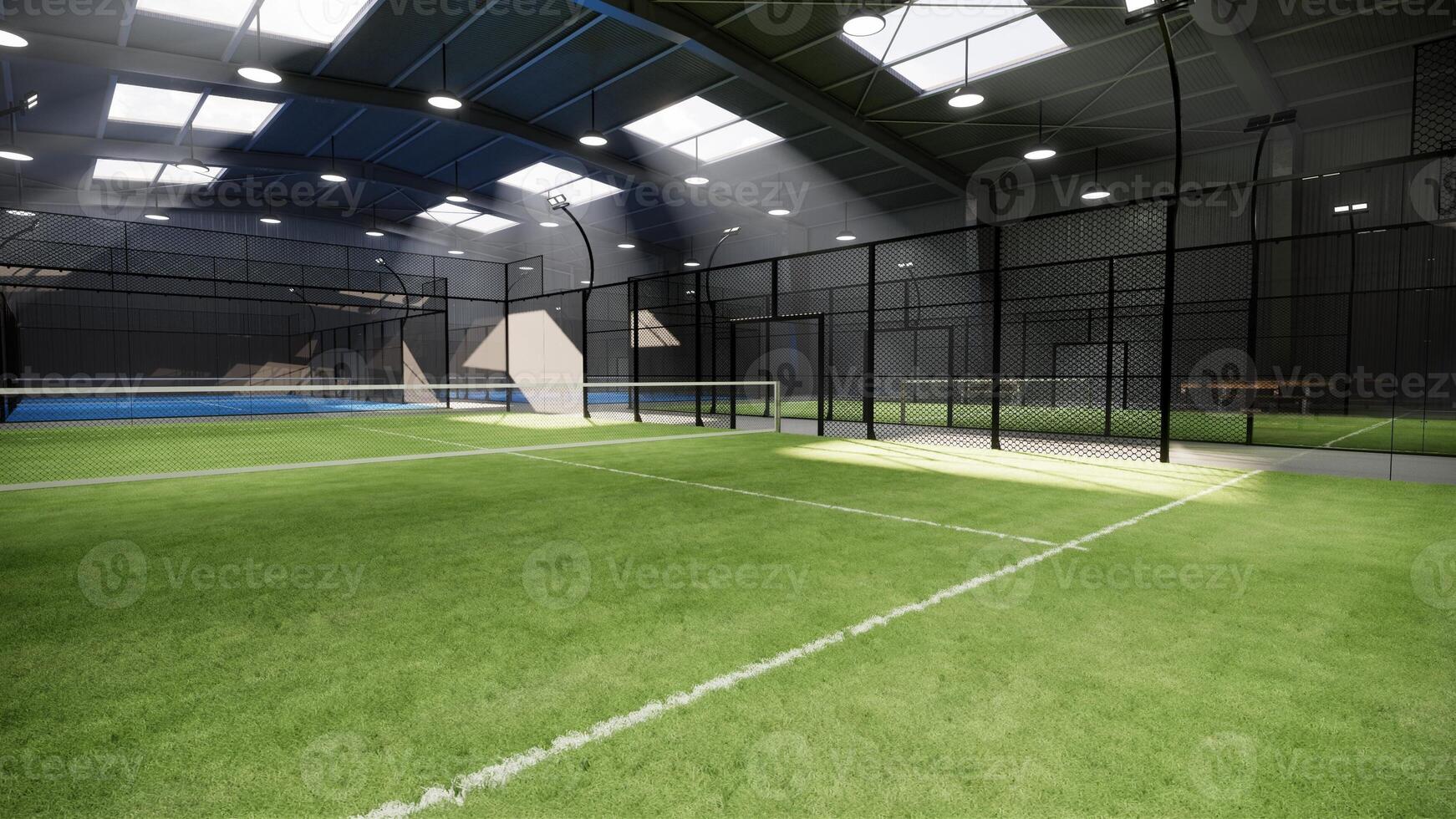 corner angle empty green padel tennis courts inside a warehouse building, situated in the sports complex facility area. With lights on during the day photo