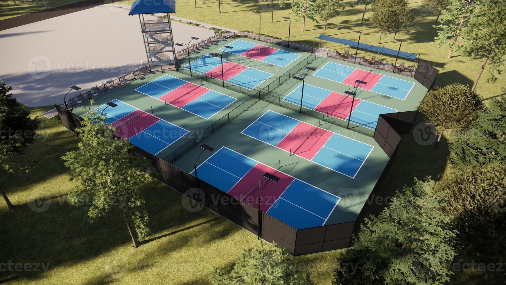 Aerial view colorful pickleball court with red, blue, and green tones, complete with lighting, fencing, and seats in a rural environment photo