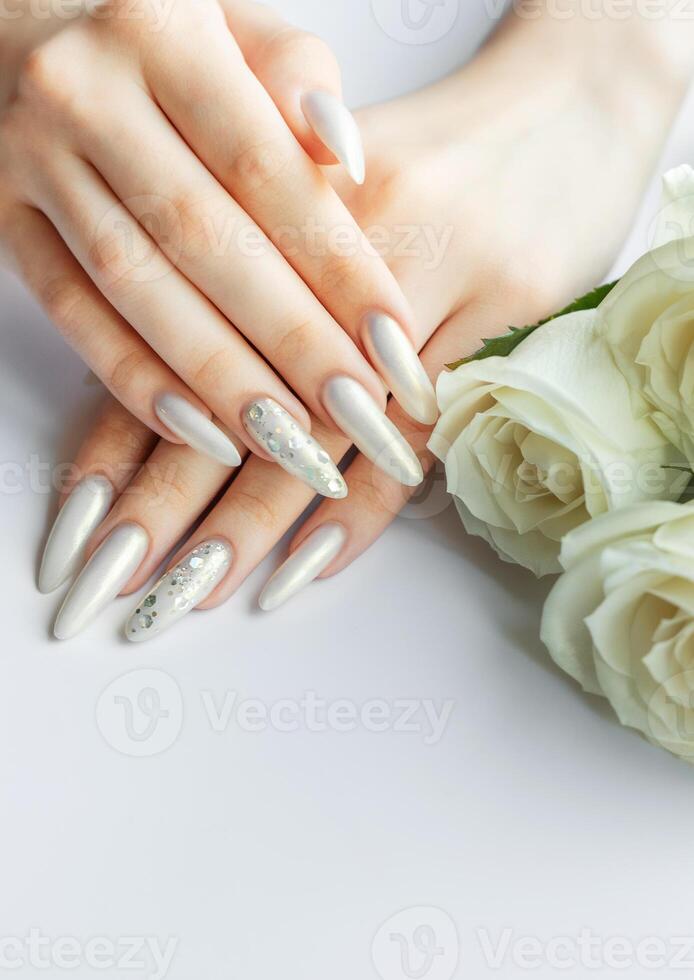 Female Hands on a white background with beautiful pearl manicure photo