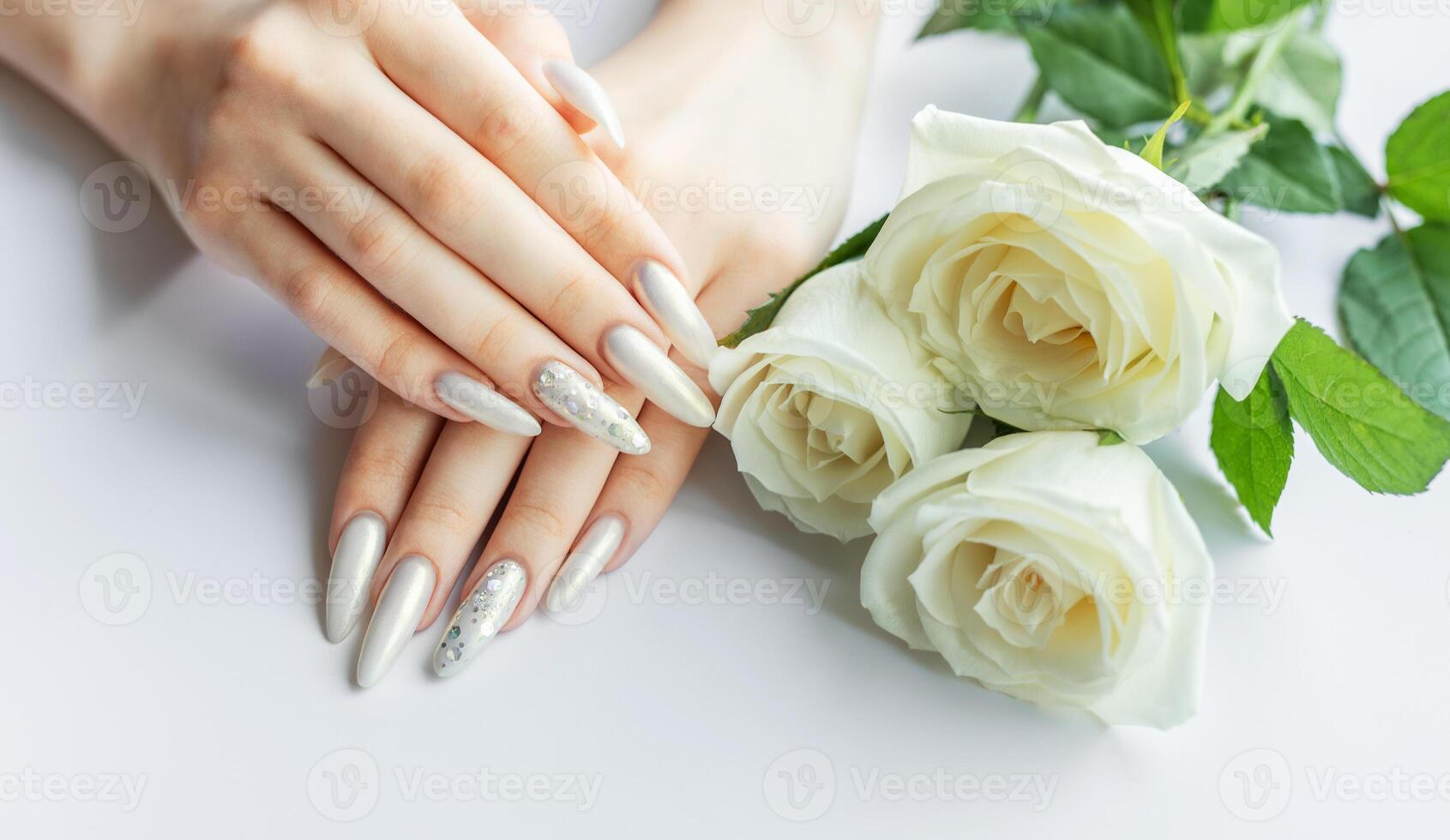 Female Hands on a white background with beautiful pearl manicure photo