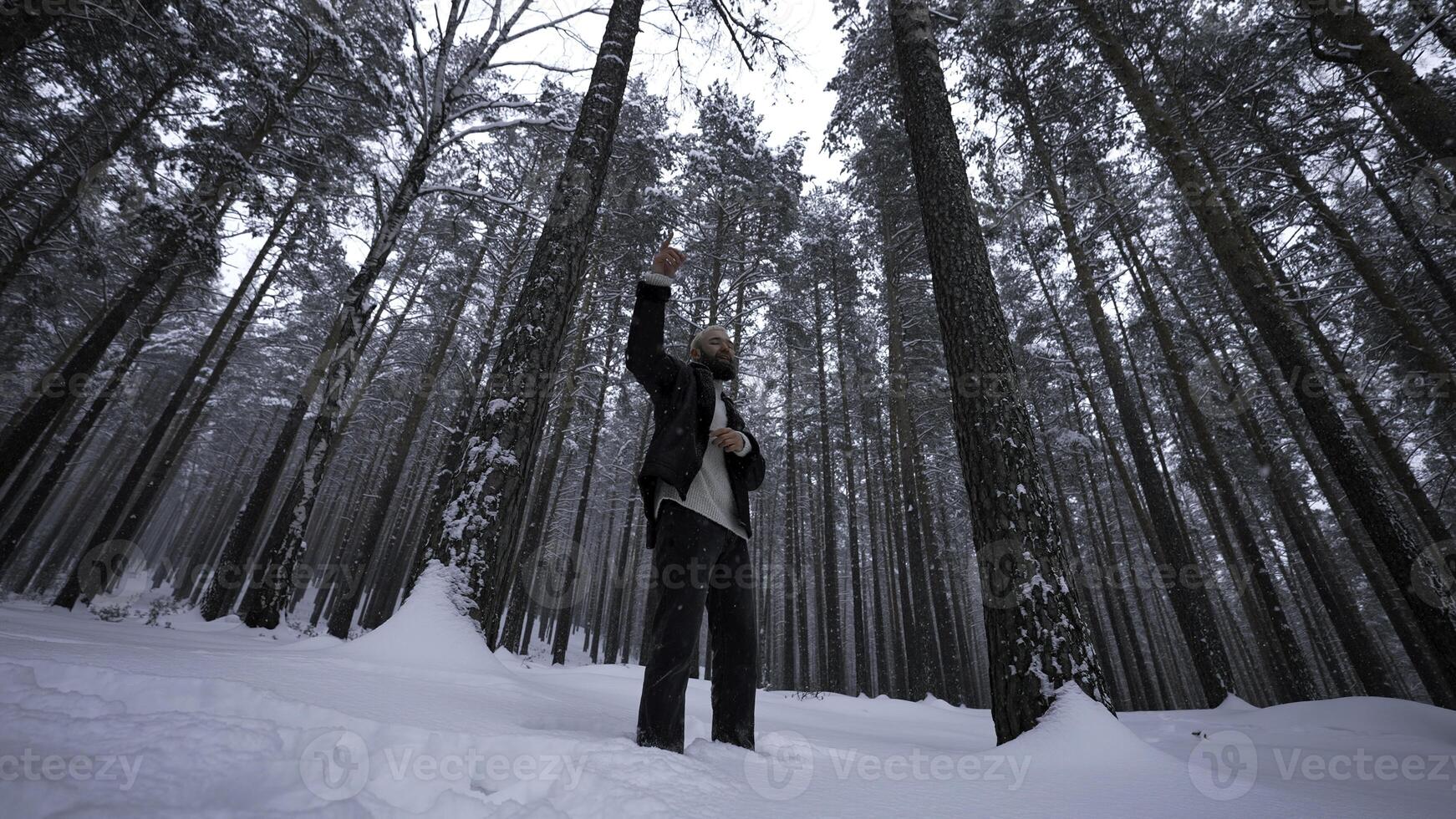 Man raps in winter forest. Media. Stylish man moves in hip hop style in winter forest. Man reads hip hop in winter forest photo