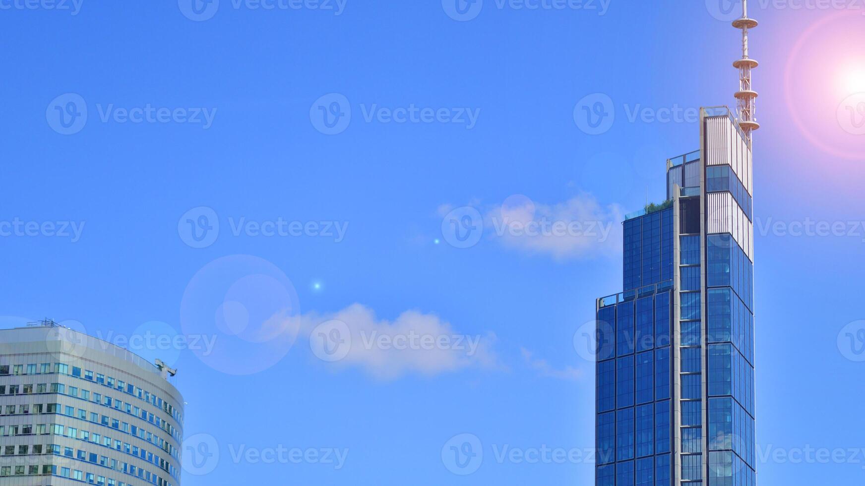 European modern office architecture. View of modern skyscrapers in business district against blue sky. Looking up at business buildings in downtown. photo