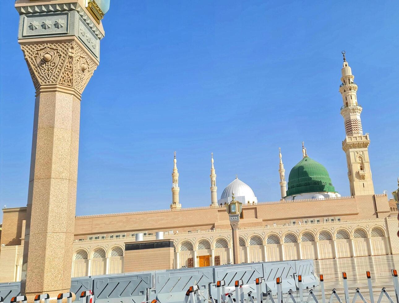 Medina, Saudi Arabia on March 1, 2024. Male and female Umrah pilgrims taking photos and walking in front of the tomb of the Prophet Muhammad at the Nabawi Mosque.