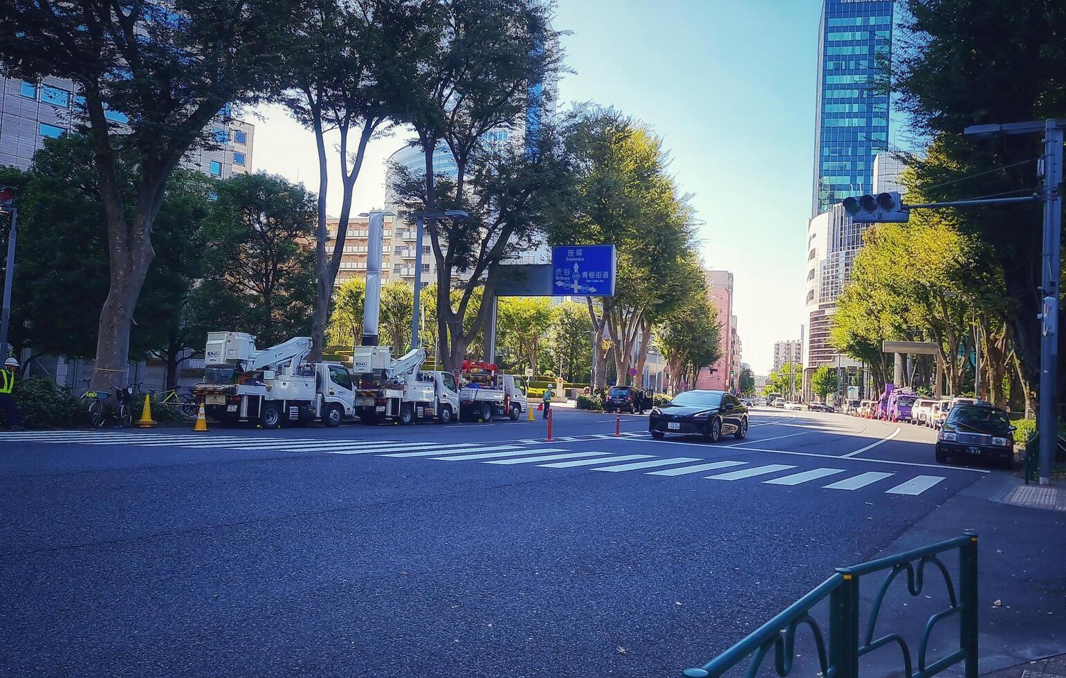 Tokyo, Japan on October 1, 2023. Several people are walking on a zebra crossing, crossing the road on one of the streets in the Tokyo area, you can see signs pointing to Sanazaka and Shibuya. photo