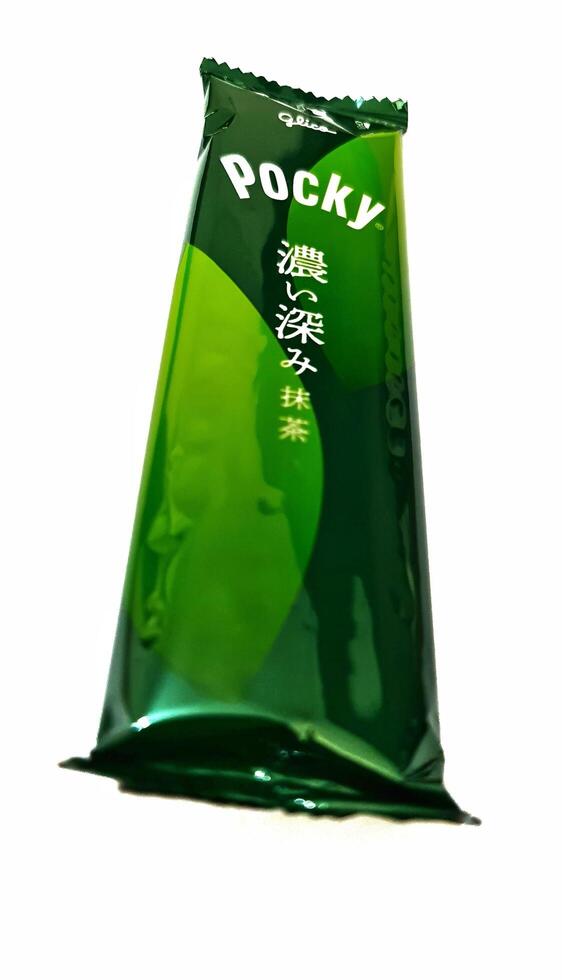 Osaka, Japan on October 1, 2023. A plastic pack of Matcha Flavored Pocky with Japanese writing on the packaging. photo