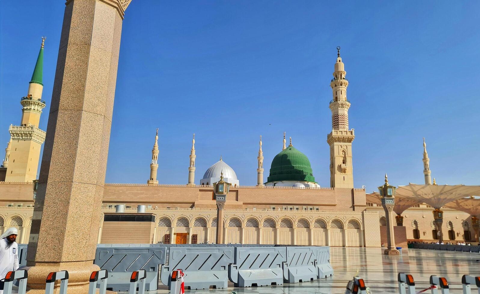 Medina, Saudi Arabia on March 1, 2024. Male and female Umrah pilgrims taking photos and walking in front of the tomb of the Prophet Muhammad at the Nabawi Mosque.