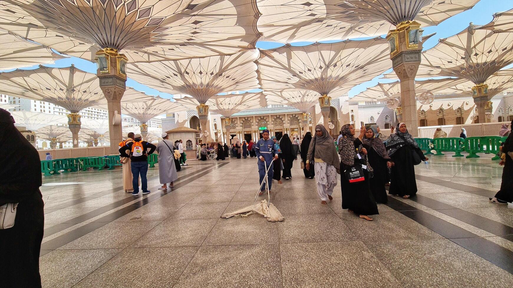 Medina, Saudi Arabia on March 2, 2024. Point of view of an Umrah or Hajj pilgrim walking in the courtyard of the Nabawi Mosque photo