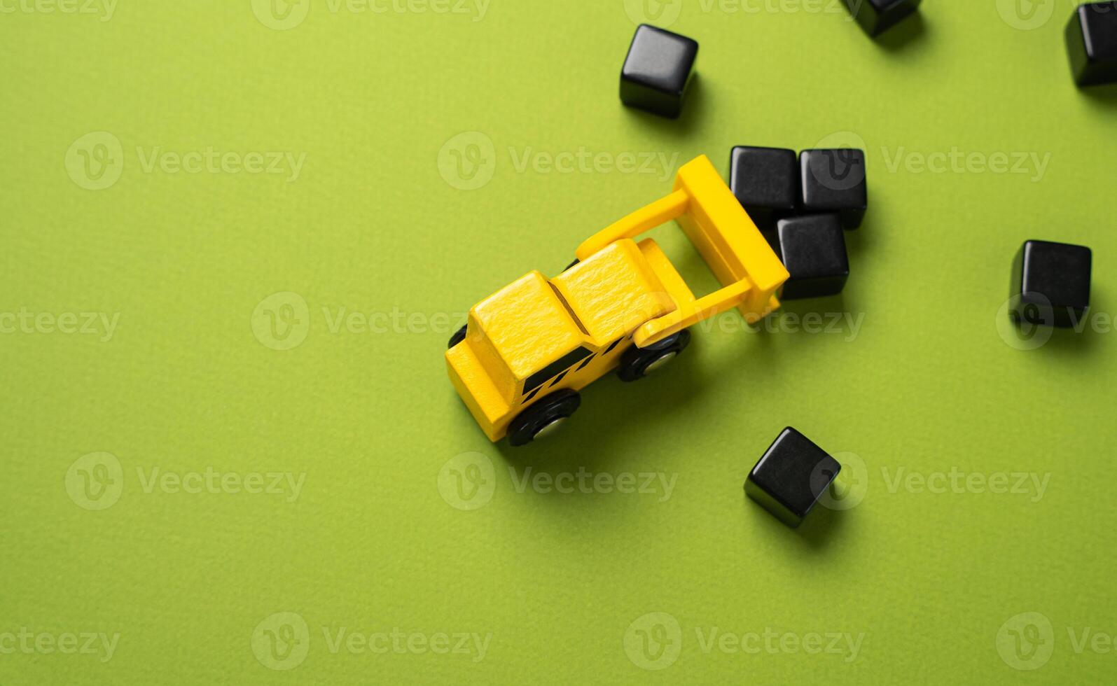 A bulldozer clears the surface of black blocks. Ecology concept. Construction and earthworks. Copy space. photo