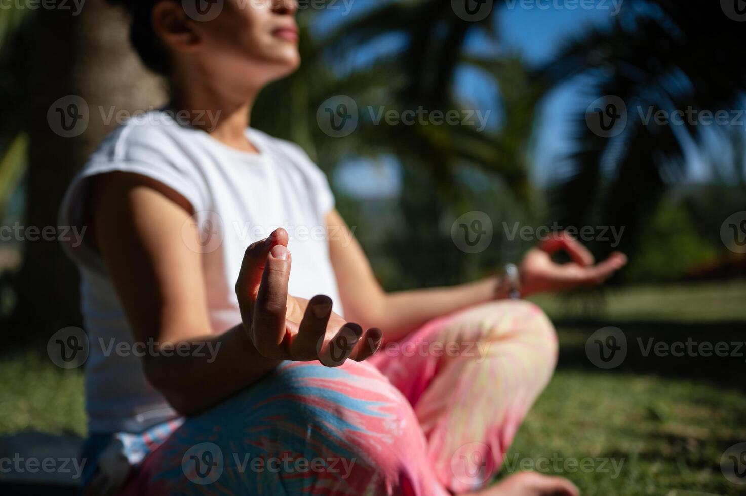 Woman meditating outdoors enjoying peaceful and relaxing environment photo