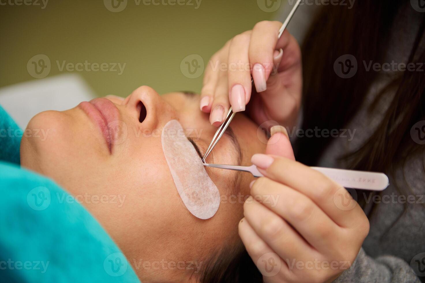 Professional eyelash extension application in beauty salon photo