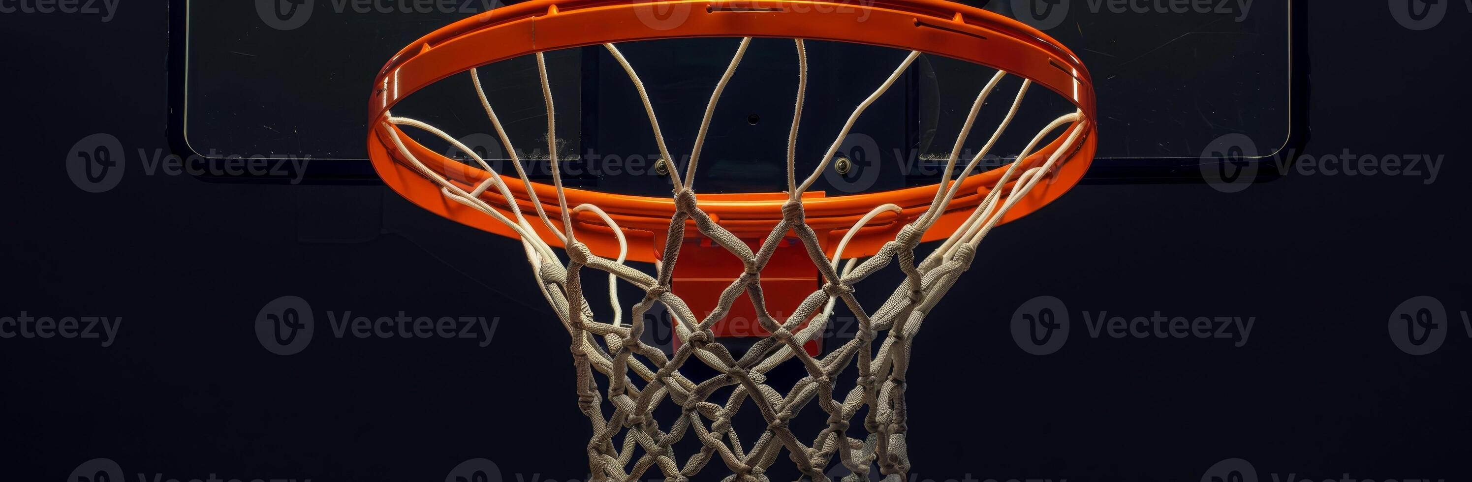 Close-up shot of a basketball hoop with a net against a dark background. Perfect for sports-themed design or promotional material. photo