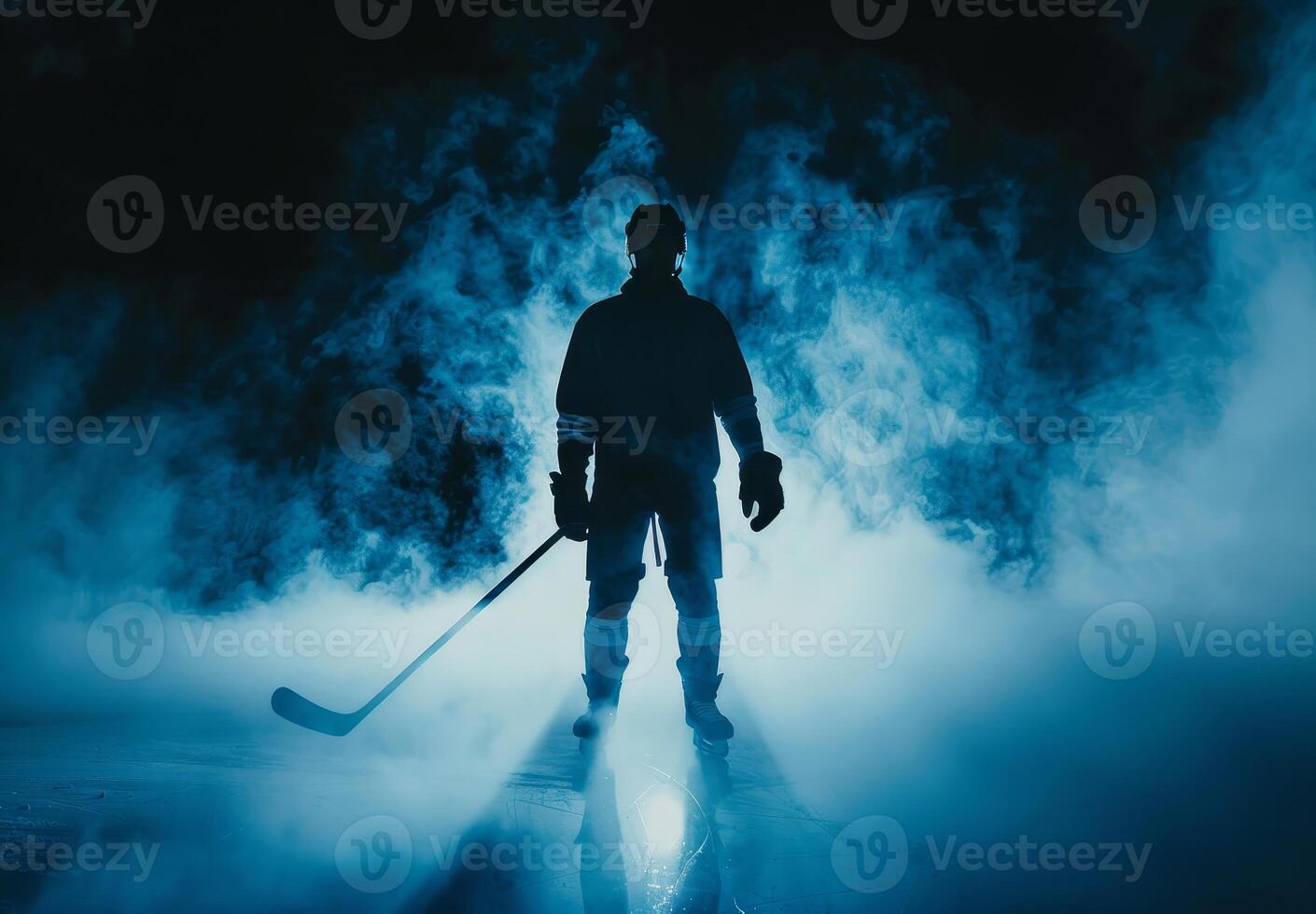 Silhouette of a hockey player holding a stick standing on an ice rink with dramatic smoke and blue light in the background. photo