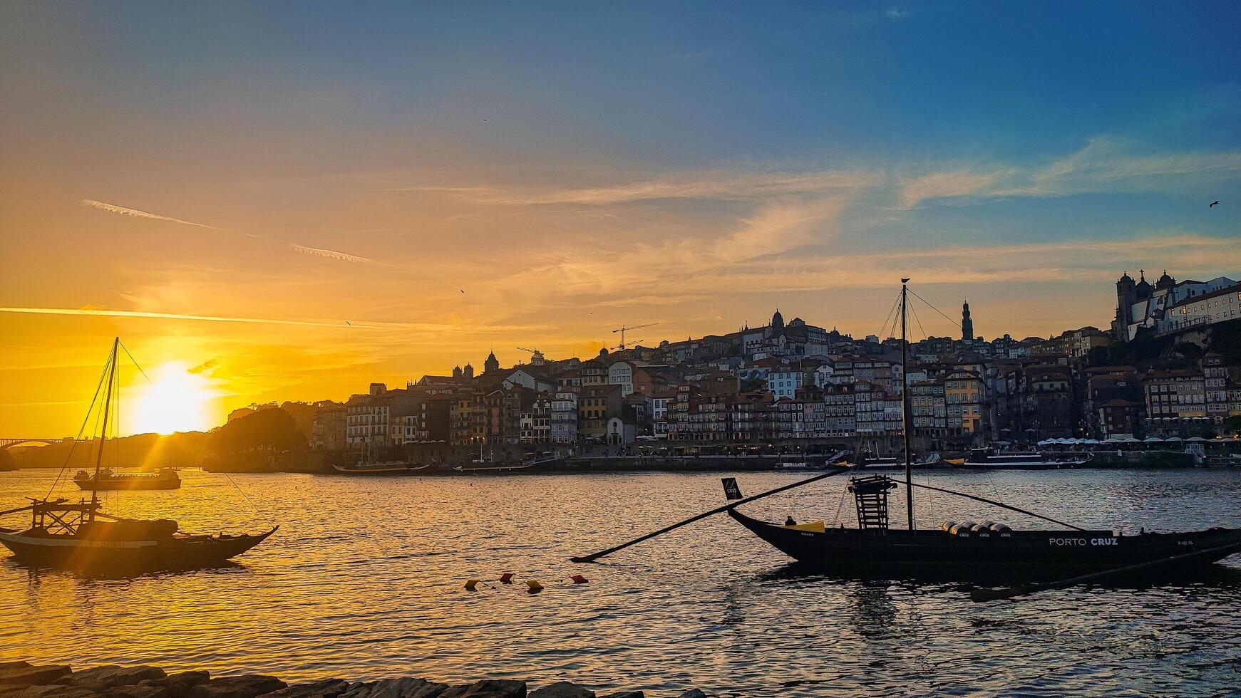PORTO, PORTUGAL - JUNE 20, 2024. Panorama of the Douro River and the old town of Porto during sunset with a view of the yachts. photo