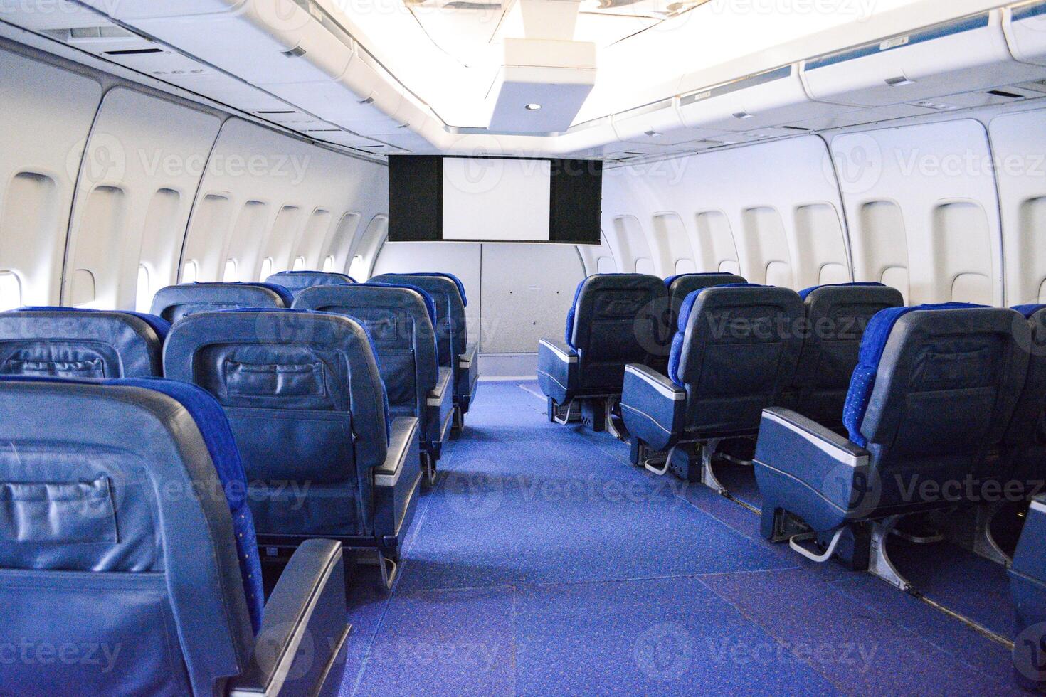 Blue empty seats in the cockpit of an airplane at the start before an air flight. photo
