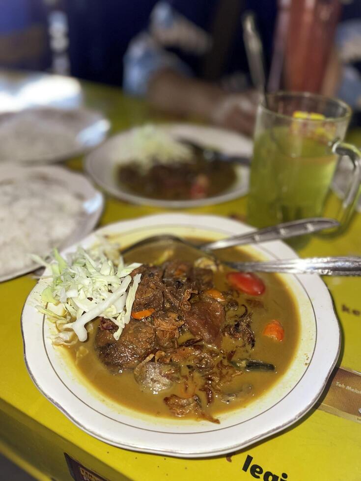 Indonesian food. Tongseng Ayam or Chicken Tongseng is a traditional Indonesian dish in the form of a savory meat soup with coconut milk and can be spicy or sweet photo