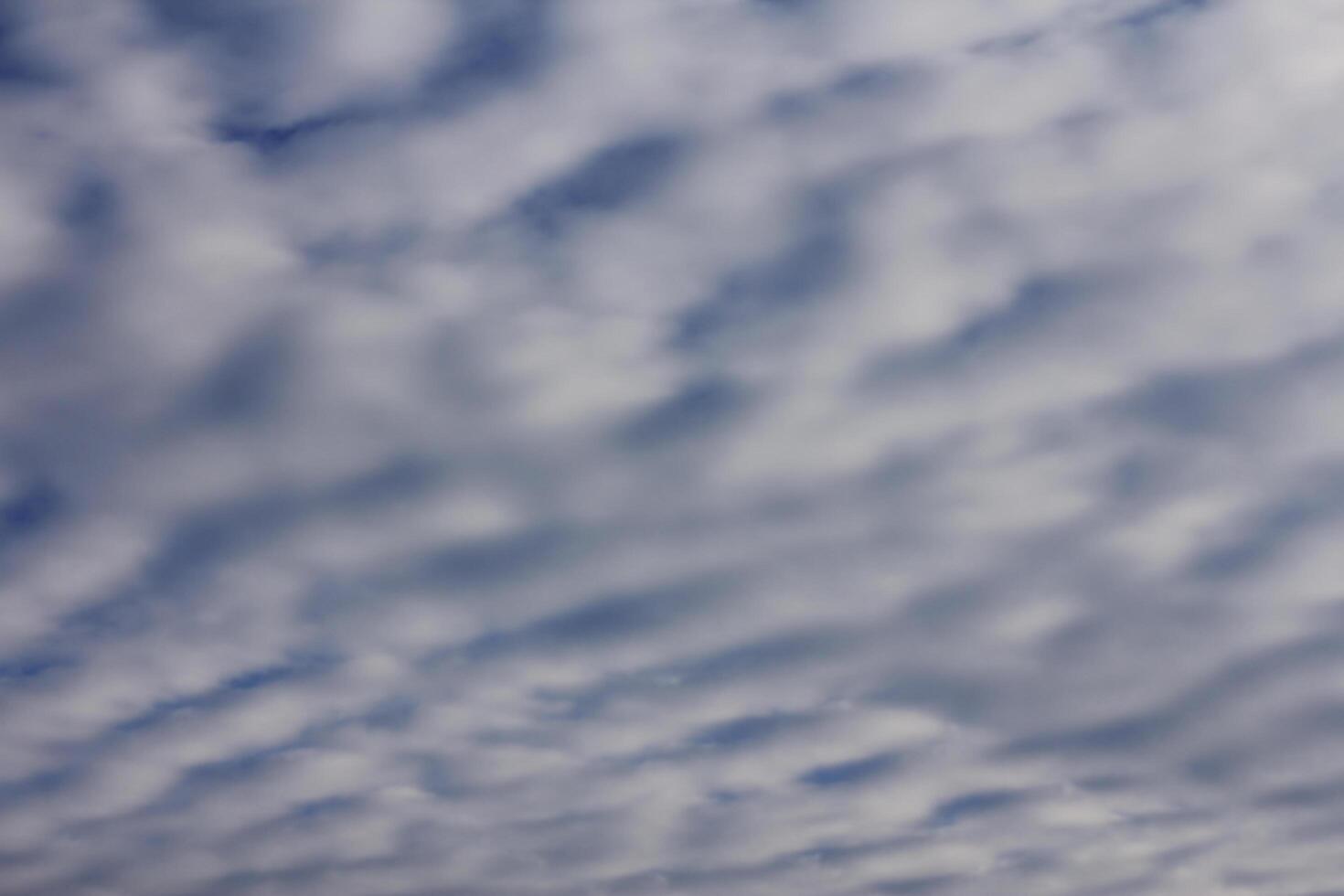 sky with layered cumulus clouds. blue background with unusual cloud texture photo