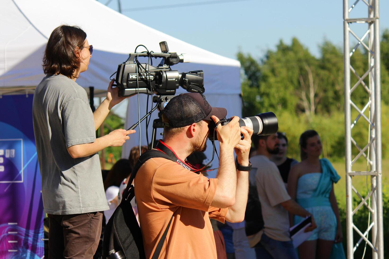 St. Petersburg, June 21, 2014 a professional photographer with a SLR camera and a male videographer with a camera shoot a public outdoor event photo