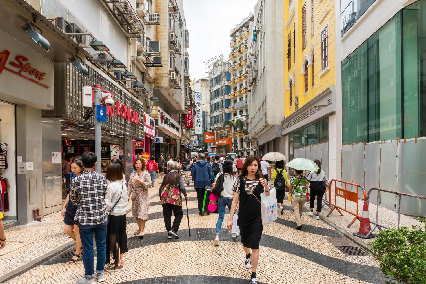 Macao, March 29, 2019-People in the streets of Macau between skyscrapers and traffic during a cloudy day photo