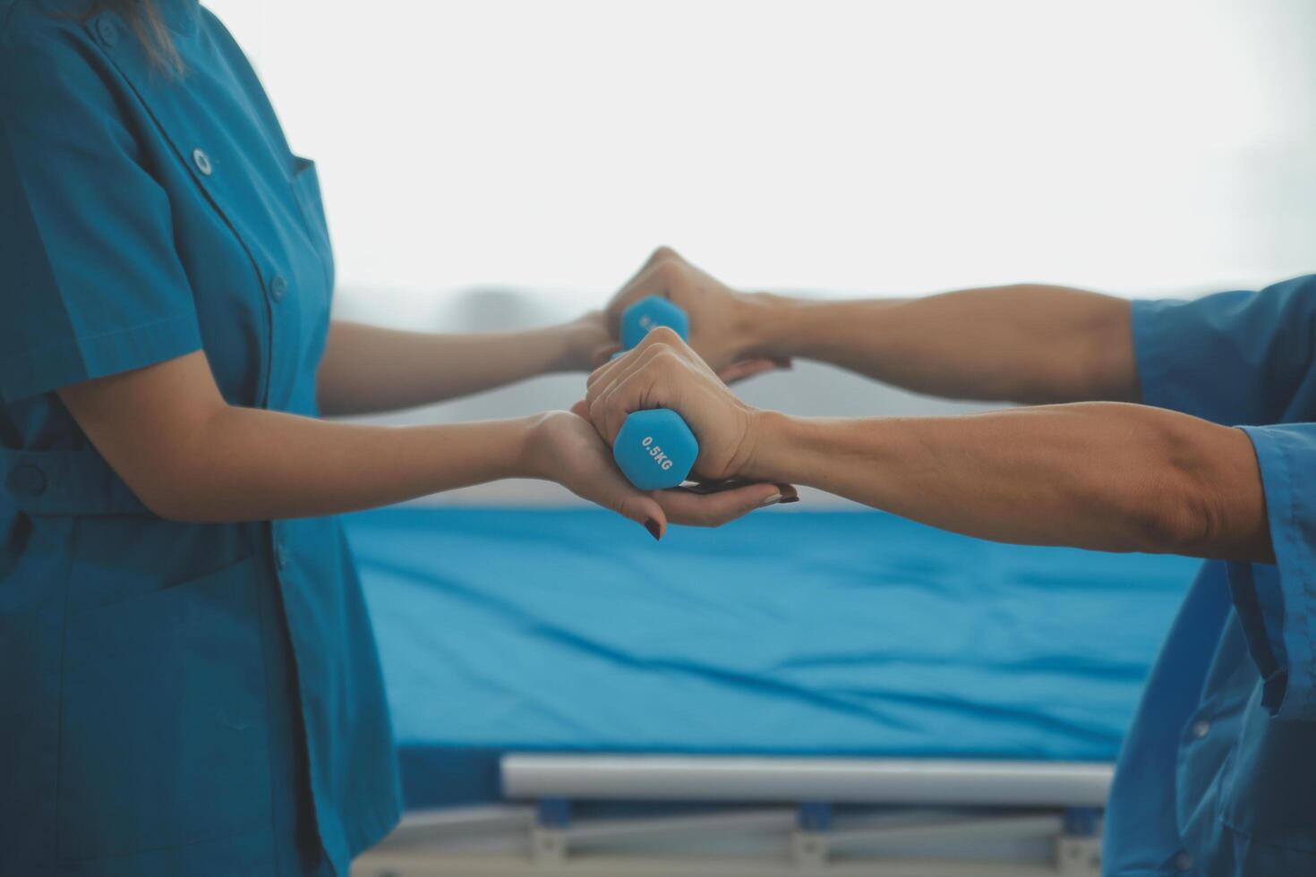 Physiotherapist man giving exercise with dumbbell treatment About Arm and Shoulder of athlete male patient Physical therapy concept photo