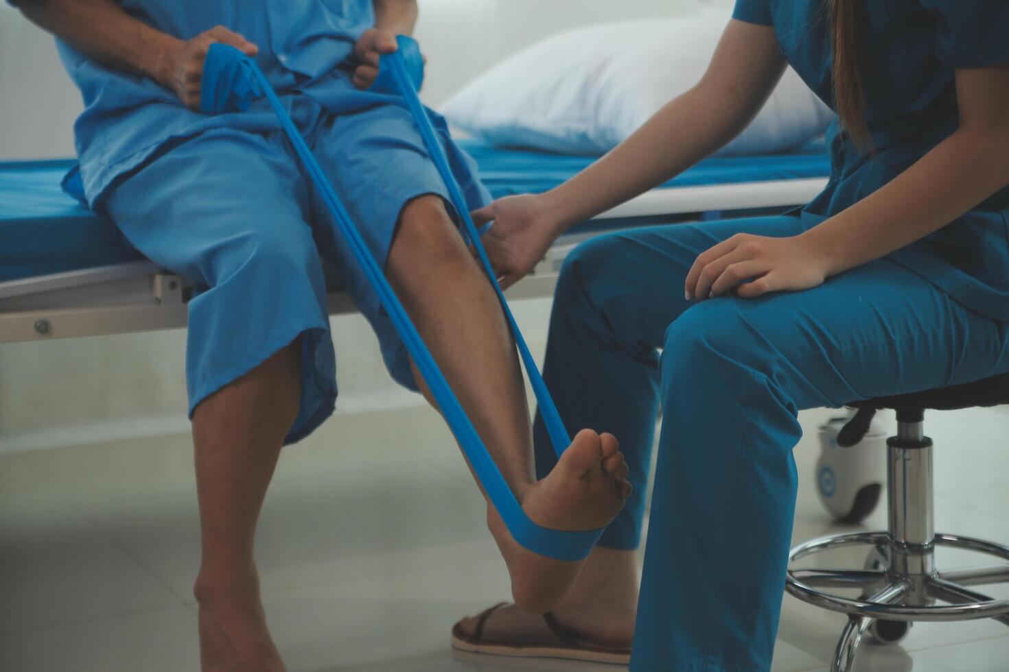Physical therapists work with patients in close-up clinics. The concept of rehabilitation of physical health, the doctor gives advice to the patient. Ankle problems and muscle injuries photo
