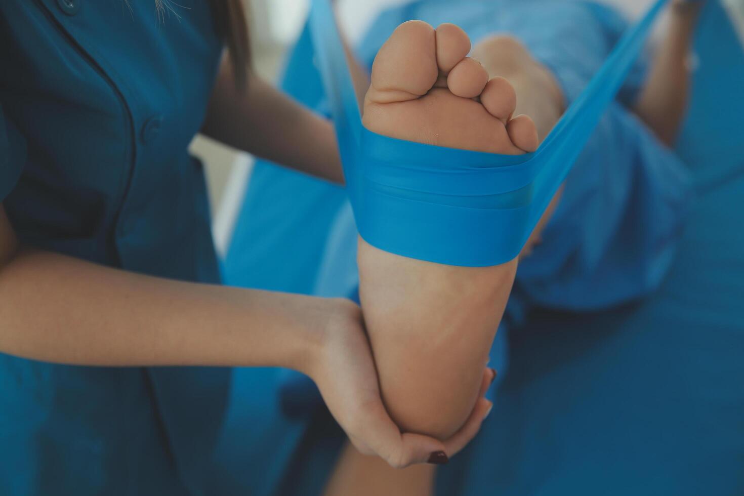 Physical therapists work with patients in close-up clinics. The concept of rehabilitation of physical health, the doctor gives advice to the patient. Ankle problems and muscle injuries photo
