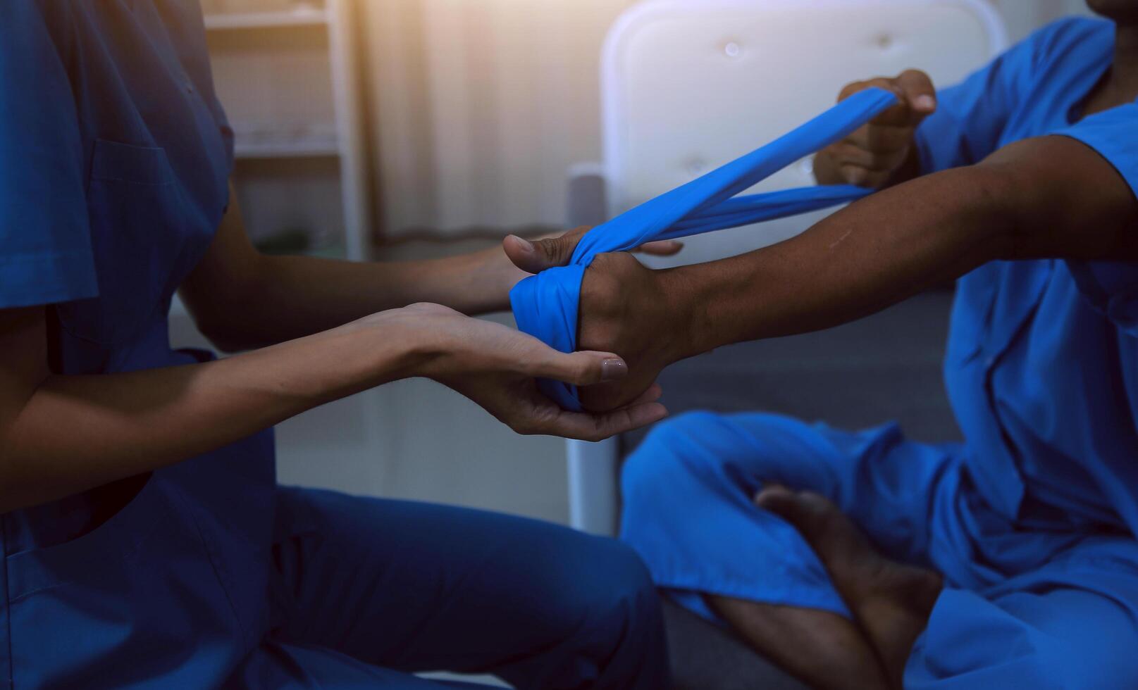 Professional physical therapist examines and cares for a young man in a physical therapy center, treating muscles and injuries of a man in a hospital. photo