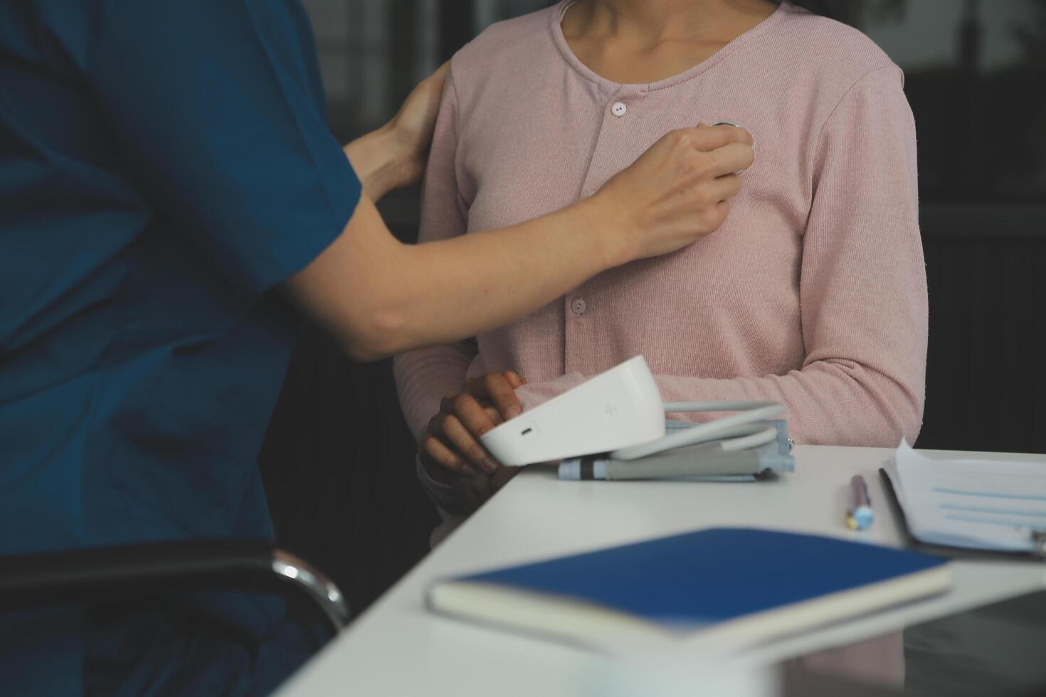 Doctor and patient discussing something while sitting at the table . Medicine and health care concept. Doctor and patient photo