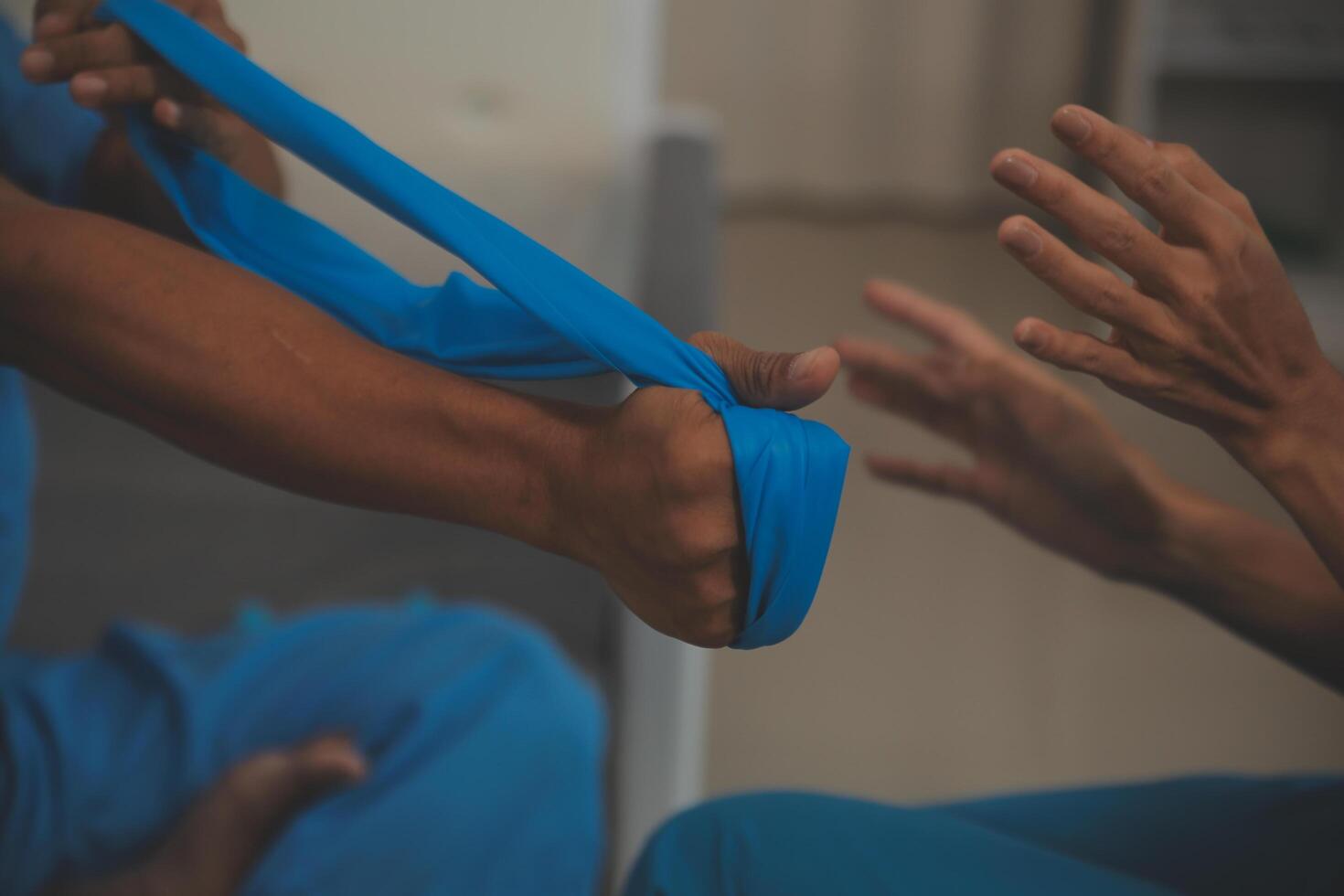 Professional physical therapist examines and cares for a young man in a physical therapy center, treating muscles and injuries of a man in a hospital. photo