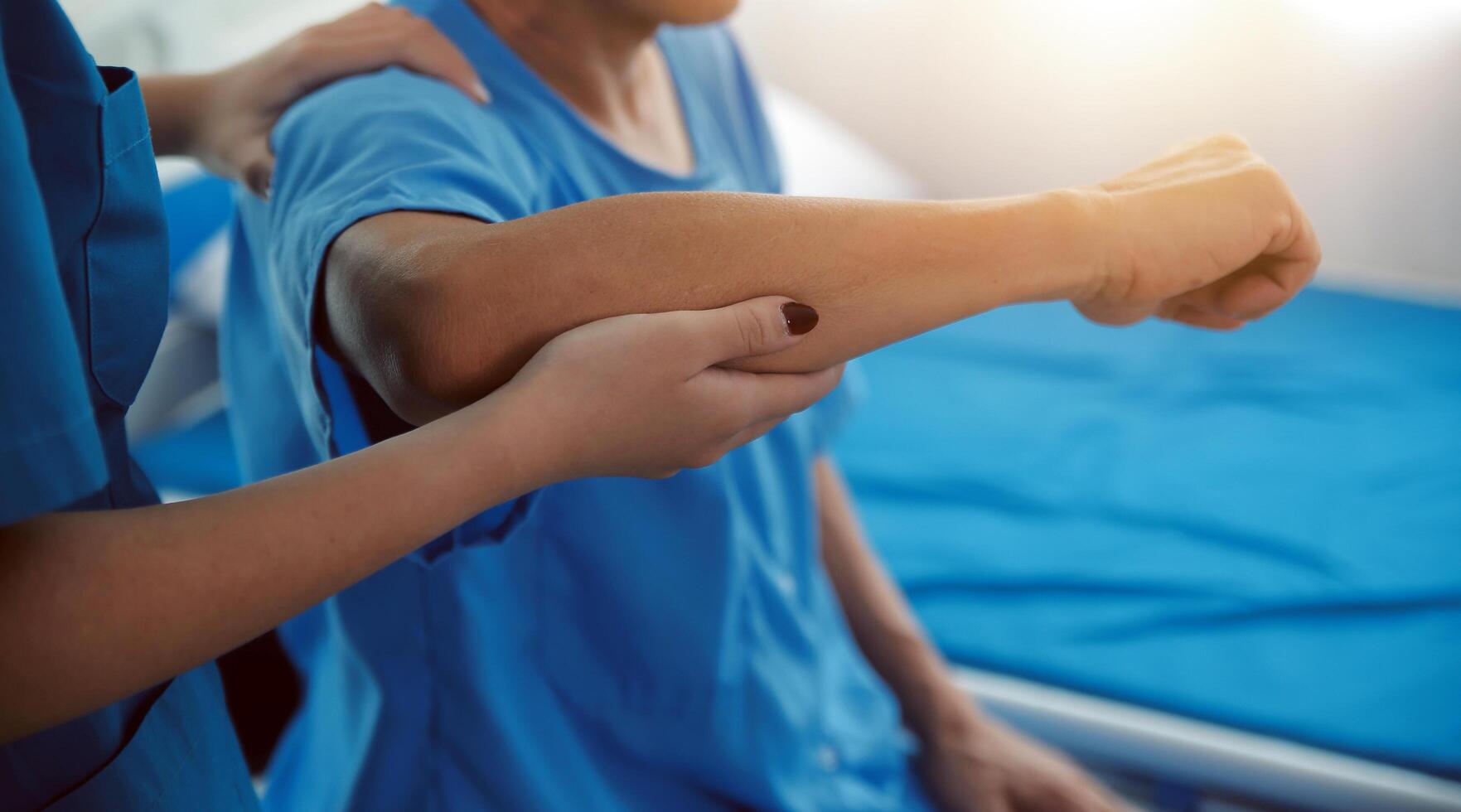 Physiotherapist man giving exercise with dumbbell treatment About Arm and Shoulder of athlete male patient Physical therapy concept photo