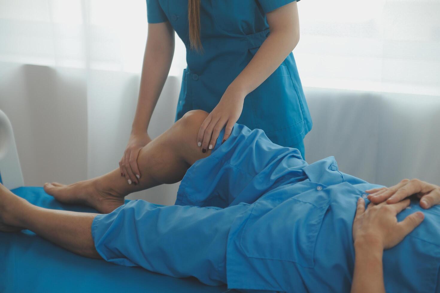 Physical therapists work with patients in close-up clinics. The concept of rehabilitation of physical health, the doctor gives advice to the patient. Ankle problems and muscle injuries photo