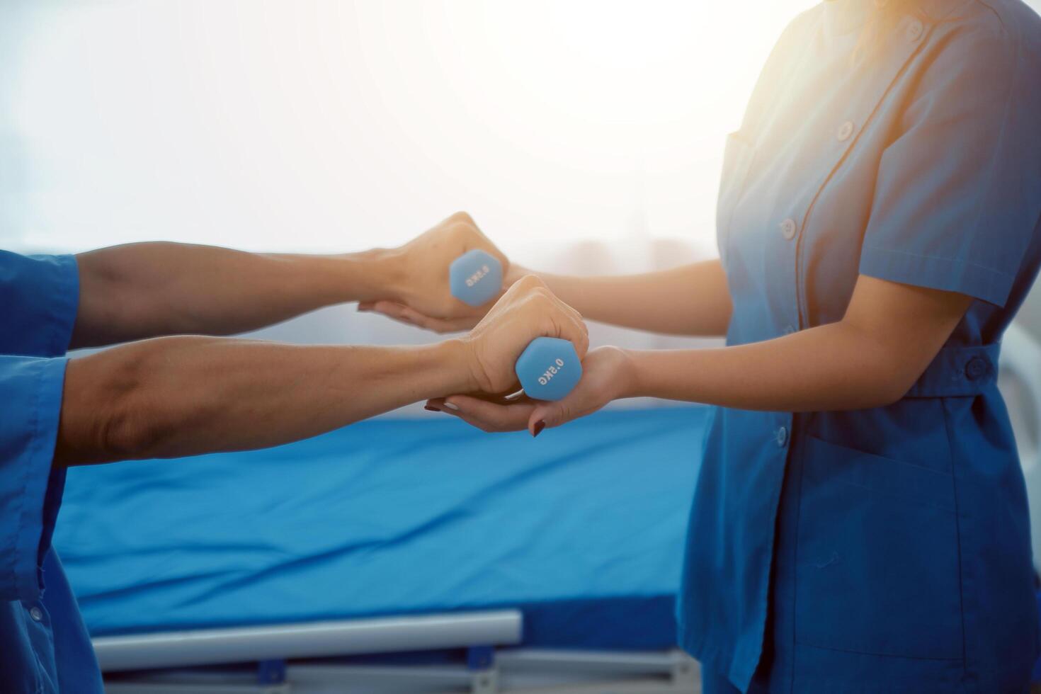 Physiotherapist man giving exercise with dumbbell treatment About Arm and Shoulder of athlete male patient Physical therapy concept photo