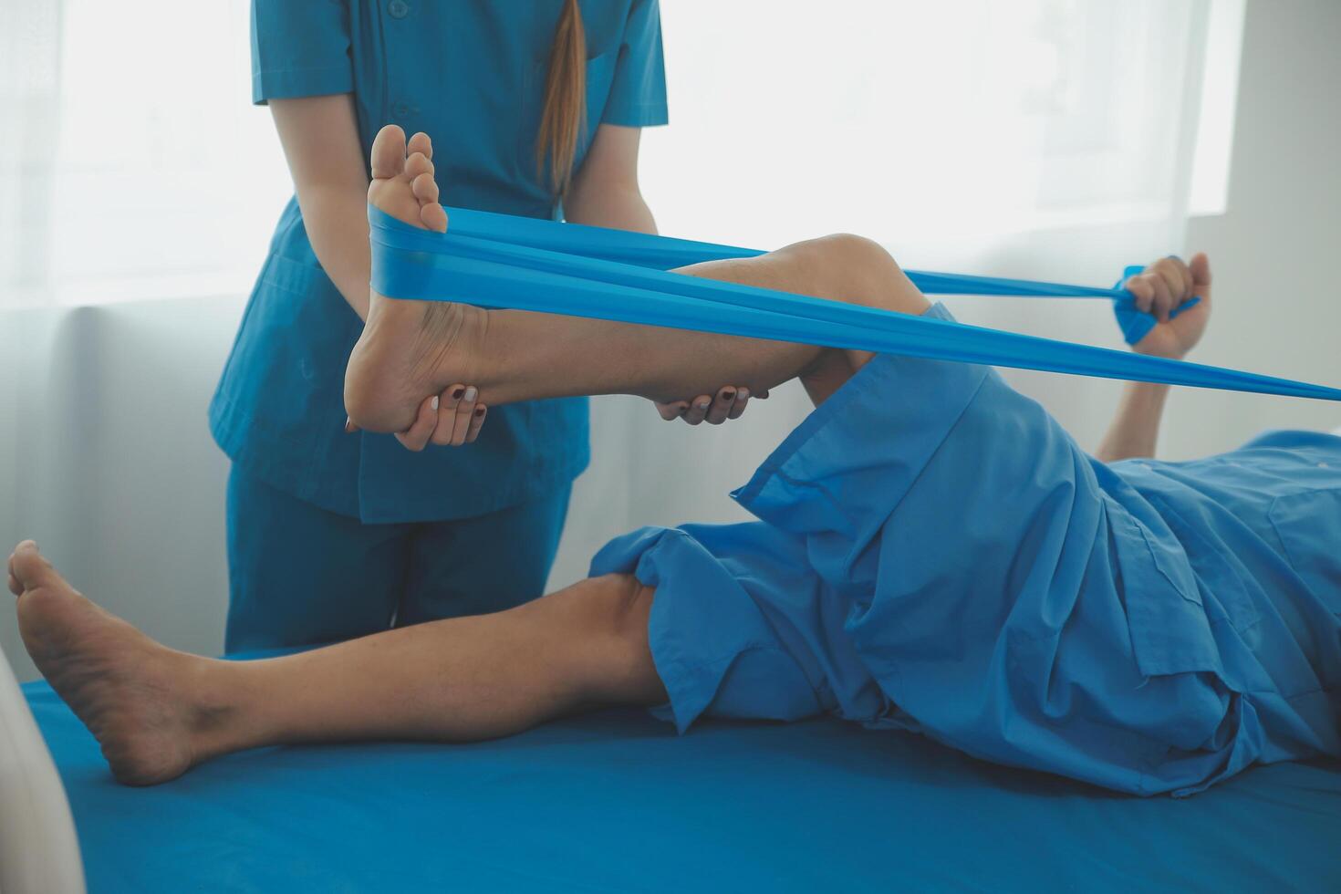 Physical therapists work with patients in close-up clinics. The concept of rehabilitation of physical health, the doctor gives advice to the patient. Ankle problems and muscle injuries photo