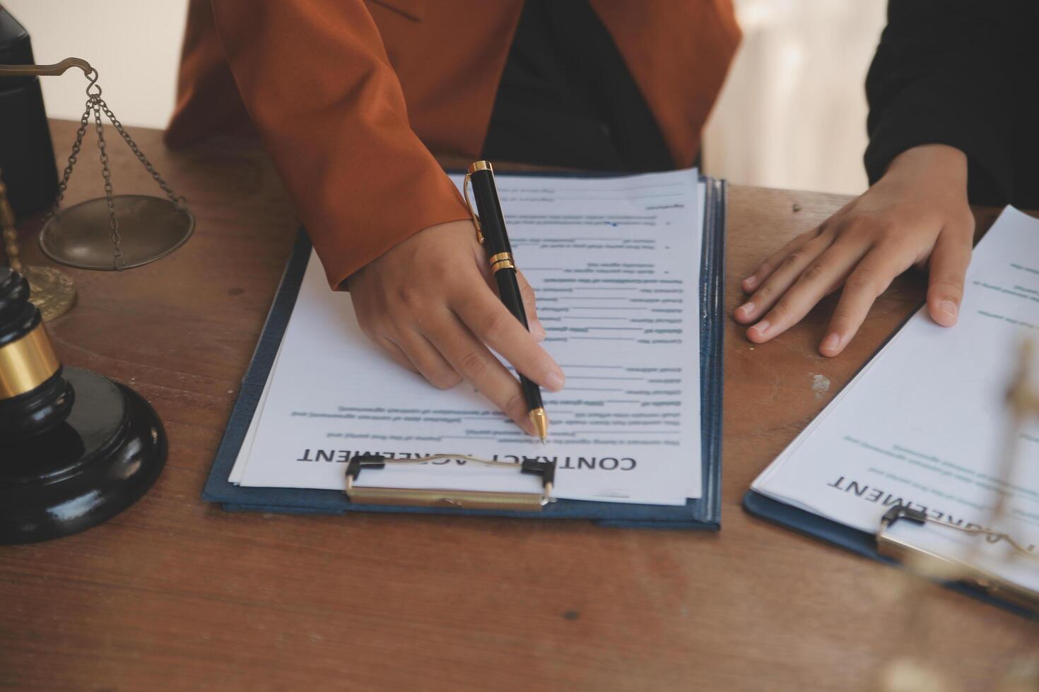 Lawyer, legal advisor, businessman brainstorming information on agreement details Business contracts in legal processing books for accuracy in contract documents. joint financial investment. photo