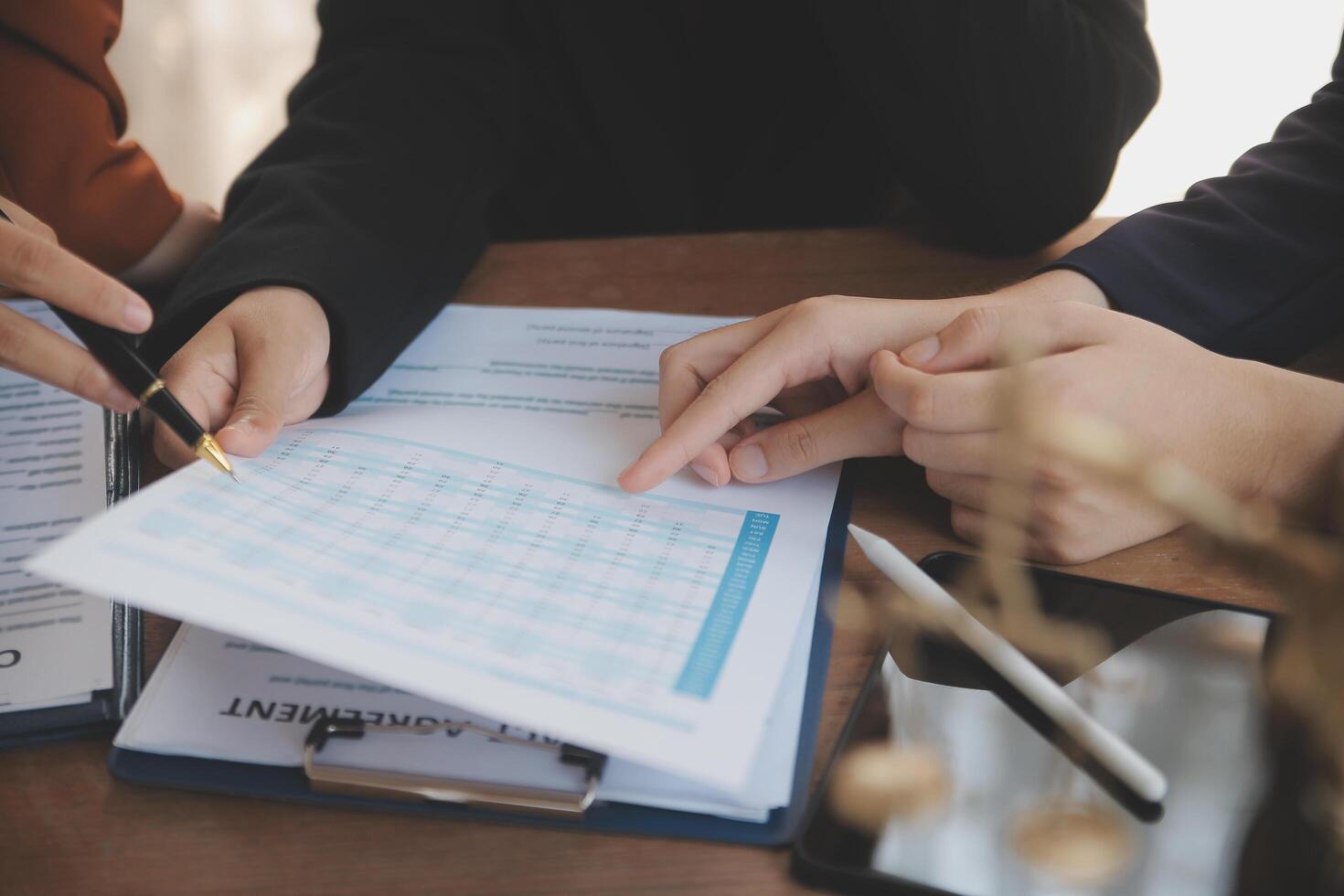 Lawyer, legal advisor, businessman brainstorming information on agreement details Business contracts in legal processing books for accuracy in contract documents. joint financial investment. photo