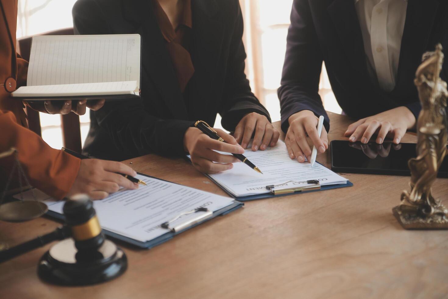 Lawyer, legal advisor, businessman brainstorming information on agreement details Business contracts in legal processing books for accuracy in contract documents. joint financial investment. photo
