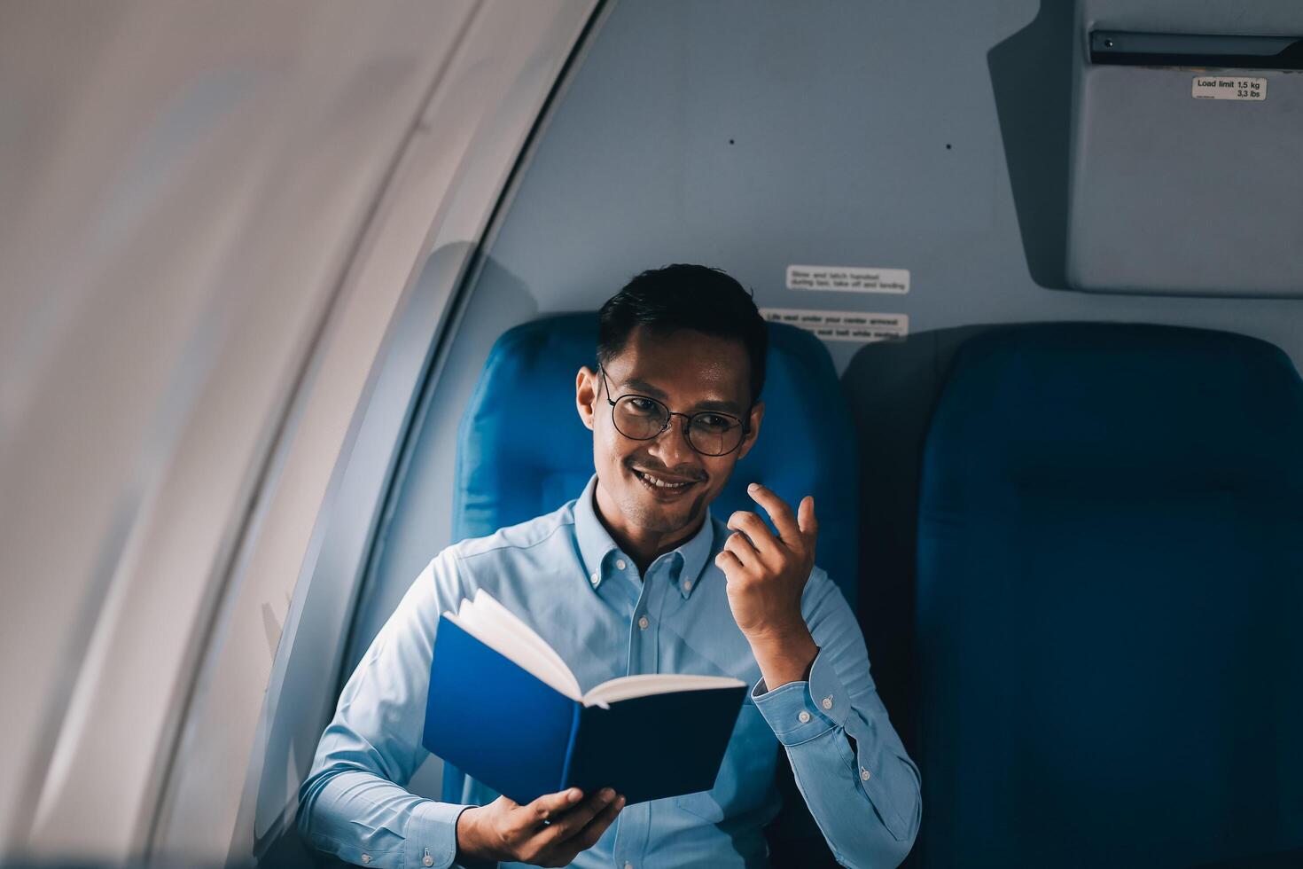 Airplane, travel and portrait of businessman working on laptop computer and smartphone while sitting in airplane. photo