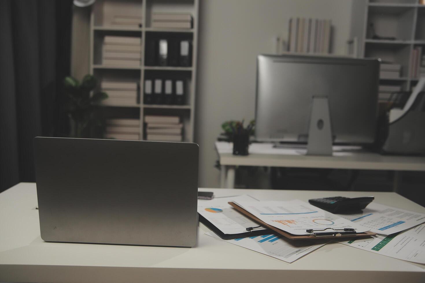 Laptop computer with opened lid on table in meeting room of office workspace. photo