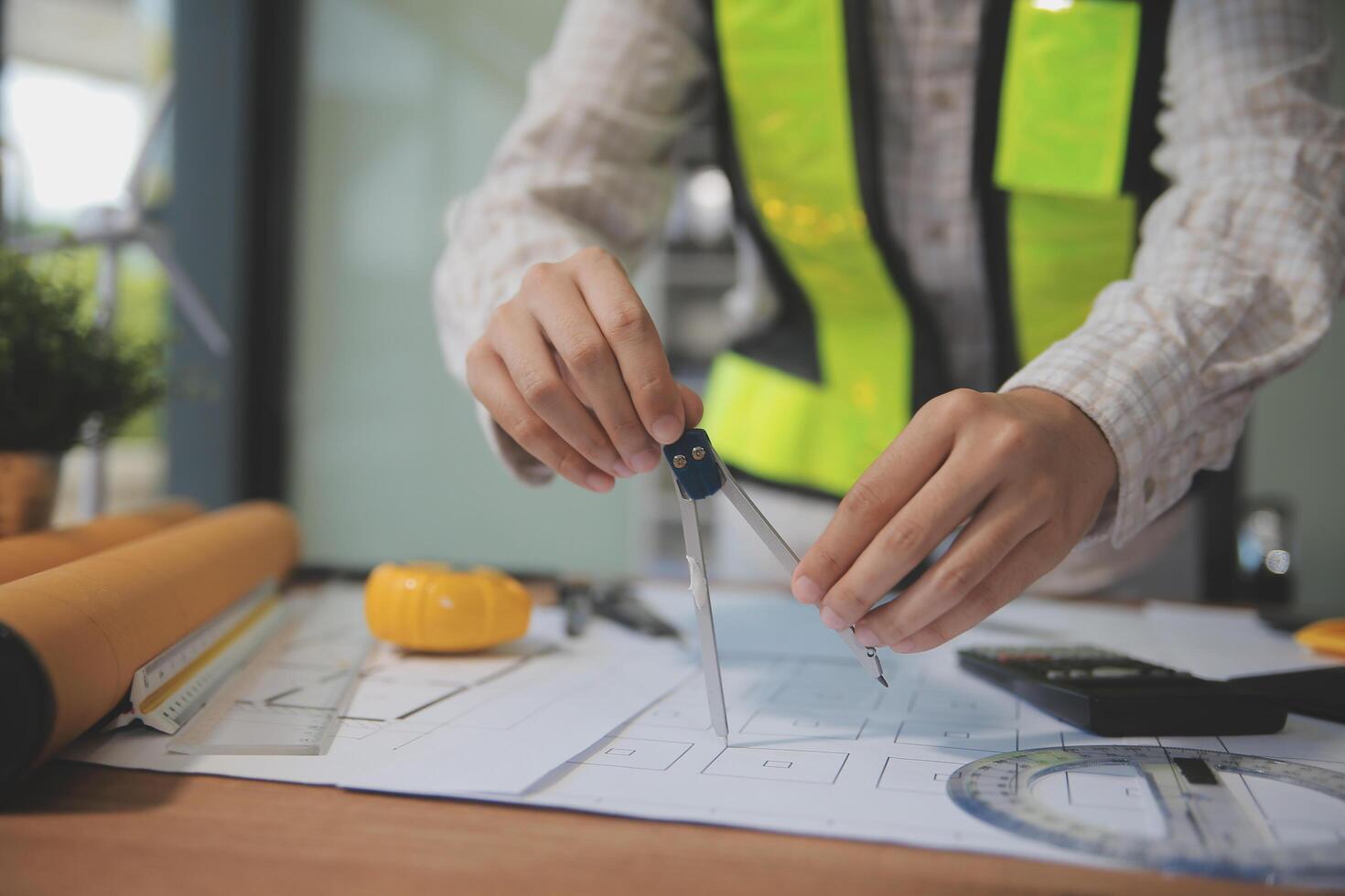 engineer people meeting working and pointing at a blueprint in office for discussing. Engineering tools and construction concept photo