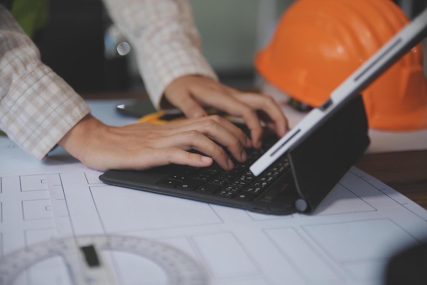 engineer people meeting working and pointing at a blueprint in office for discussing. Engineering tools and construction concept photo